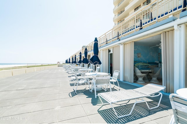 view of patio / terrace with a water view and outdoor dining space