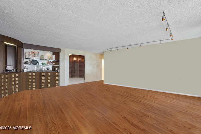 717 Ocean Ave Unit 512, Long Branch, NJ 07740 - unfurnished living room featuring a textured ceiling, track lighting, and wood finished floors
