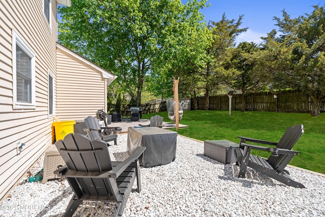 view of patio with a fenced backyard and an outdoor fire pit