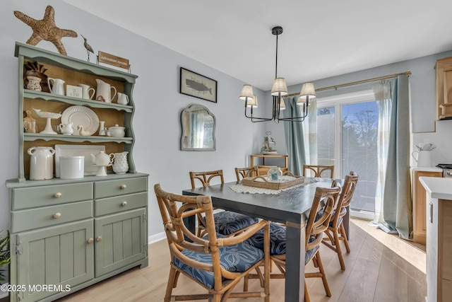 dining room with an inviting chandelier and light wood finished floors