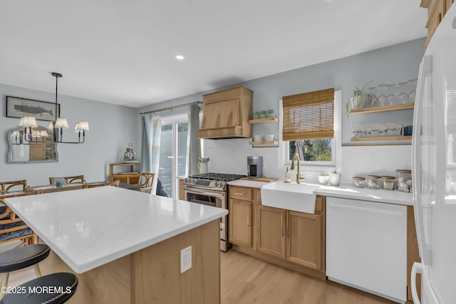 kitchen featuring a sink, open shelves, white appliances, and a healthy amount of sunlight