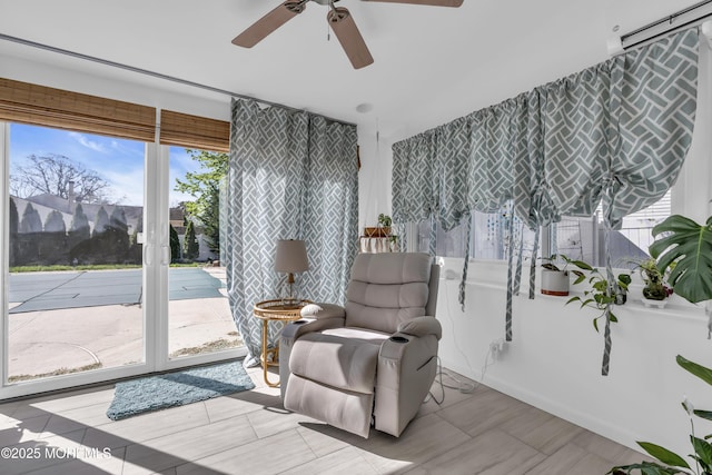 sitting room featuring a ceiling fan