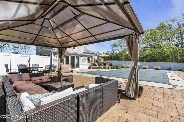 view of patio / terrace featuring outdoor dining area, a fenced backyard, an outdoor living space, a fenced in pool, and a gazebo