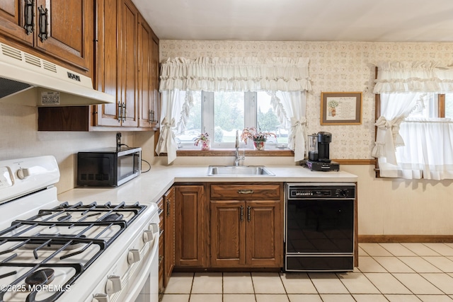 2174 Begonia Ave, Sea Girt, NJ 08750 - kitchen with white gas stove, black dishwasher, under cabinet range hood, a sink, and wallpapered walls