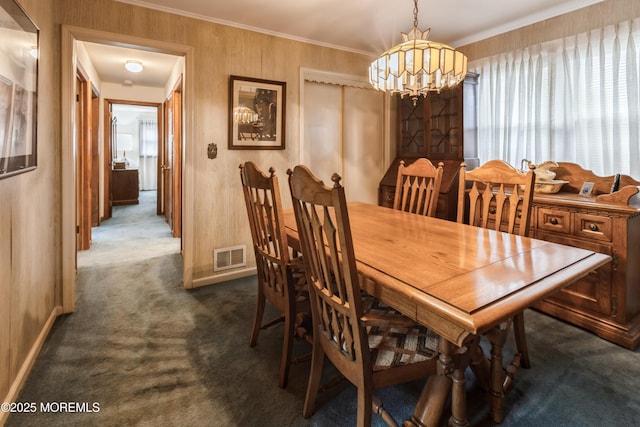 2174 Begonia Ave, Sea Girt, NJ 08750 - dining room with dark carpet, a chandelier, baseboards, and ornamental molding