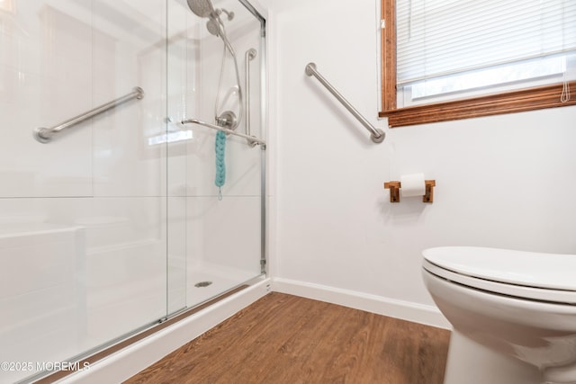 2174 Begonia Ave, Sea Girt, NJ 08750 - bathroom featuring wood finished floors, a stall shower, baseboards, and toilet