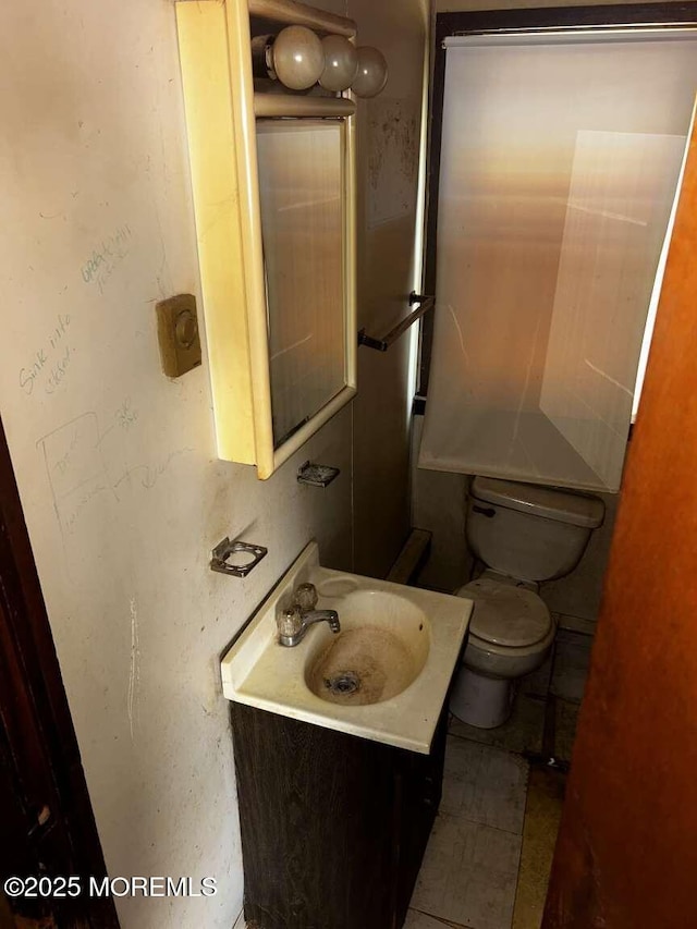 half bathroom with toilet and vanity