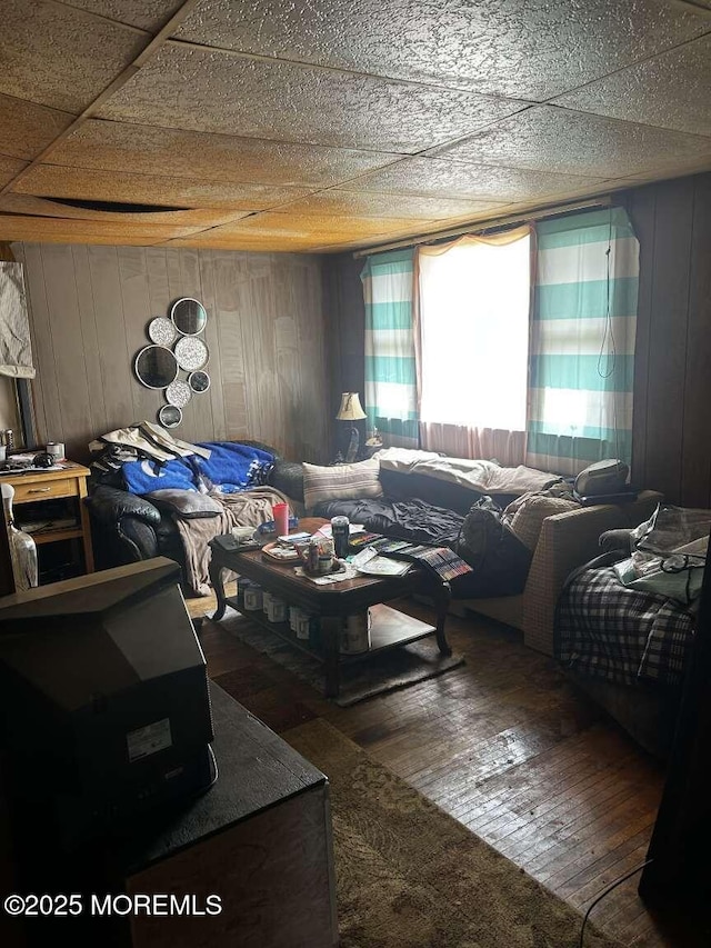 bedroom with wooden walls and wood-type flooring