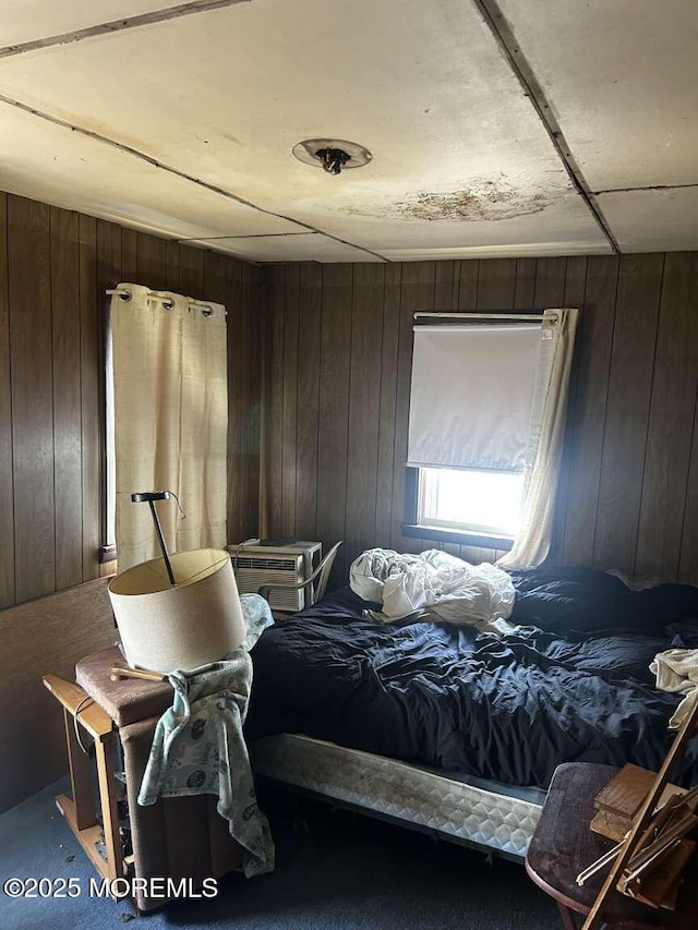 bedroom featuring wooden walls
