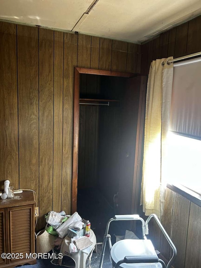 bedroom with wood walls