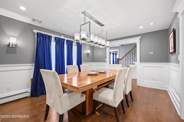 dining area with visible vents, wainscoting, stairs, and an inviting chandelier