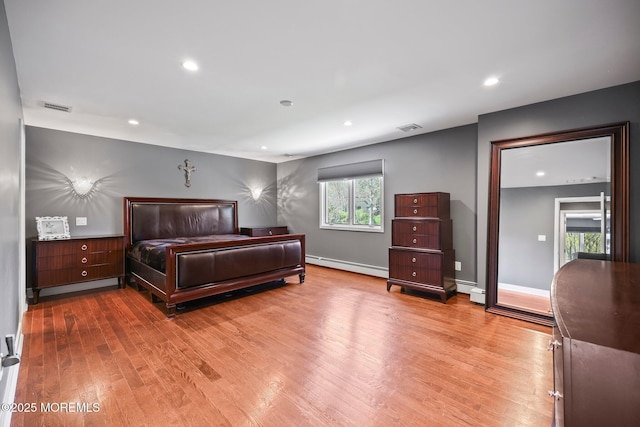 bedroom featuring recessed lighting, visible vents, wood finished floors, and a baseboard radiator