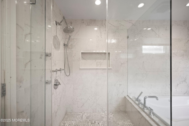 bathroom with a shower stall, recessed lighting, and a bath
