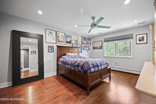 bedroom with a ceiling fan, visible vents, hardwood / wood-style flooring, a baseboard radiator, and recessed lighting
