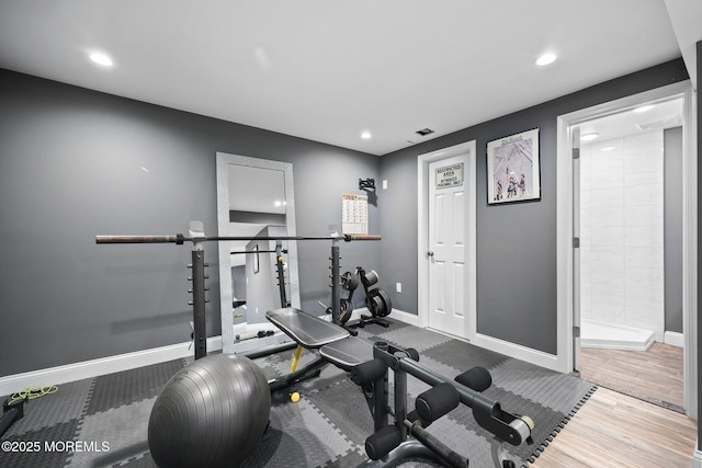 workout area with baseboards, recessed lighting, and wood finished floors