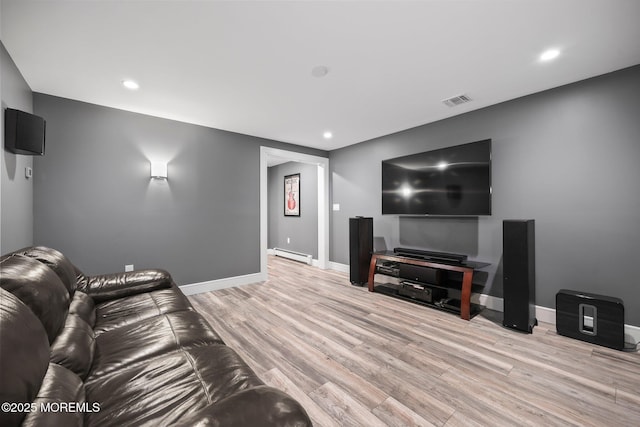 living room featuring recessed lighting, baseboards, light wood-type flooring, and a baseboard radiator