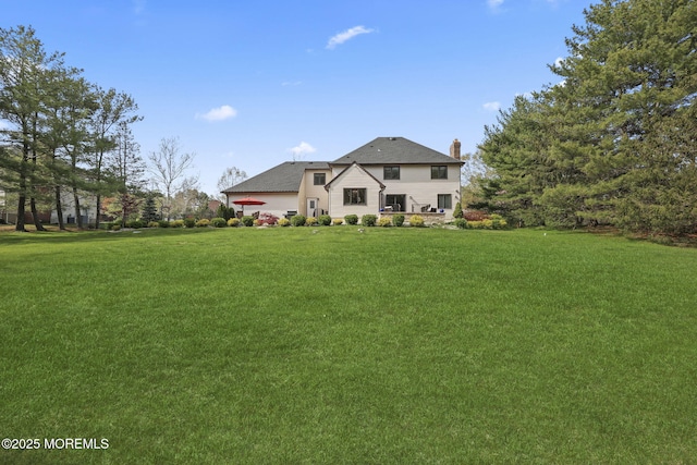 view of front of house featuring a front lawn and a chimney