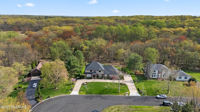 birds eye view of property with a forest view