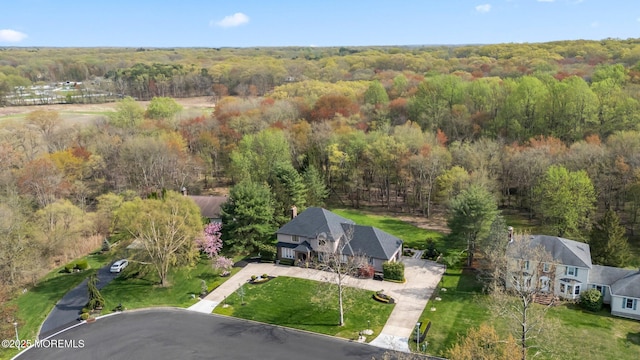 drone / aerial view featuring a wooded view