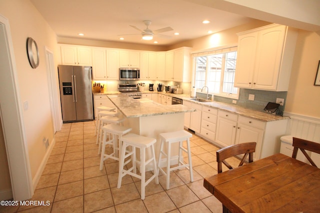 12 23rd Ave, South Seaside Park, NJ 08752 - kitchen featuring appliances with stainless steel finishes, a sink, white cabinets, tasteful backsplash, and recessed lighting