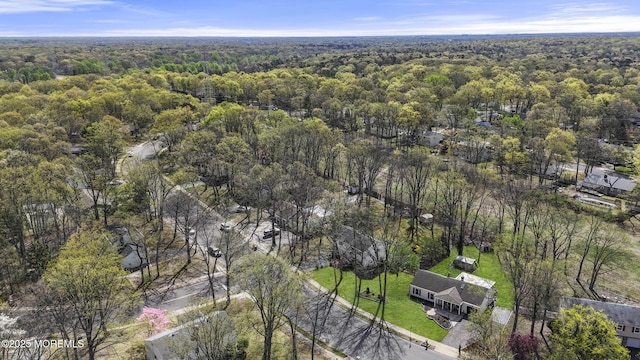 birds eye view of property with a view of trees