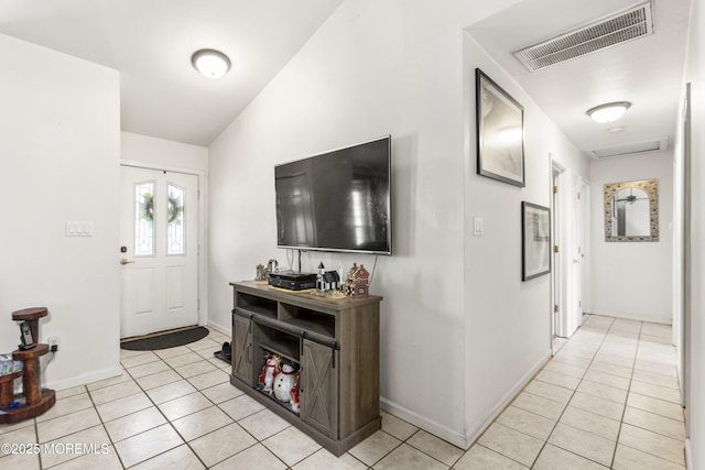 entryway with baseboards, visible vents, and light tile patterned floors
