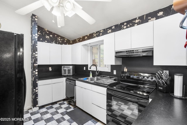 kitchen featuring dark countertops, a sink, black appliances, lofted ceiling, and under cabinet range hood