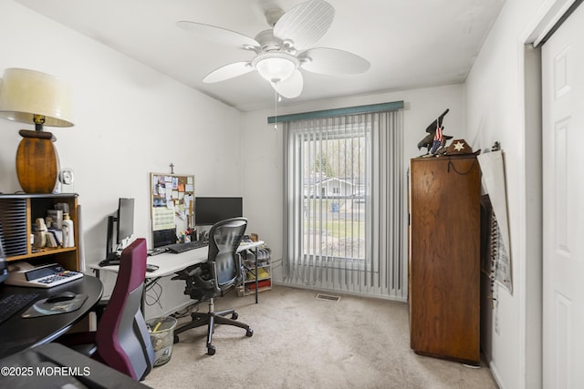 carpeted home office with visible vents and a ceiling fan