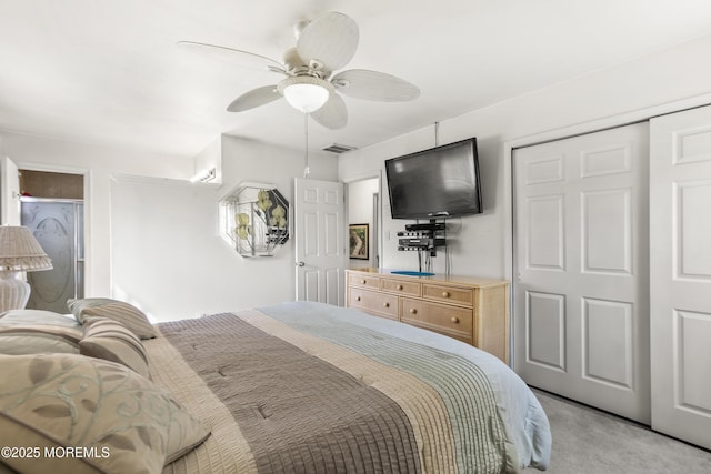 bedroom featuring a closet, ceiling fan, light colored carpet, and visible vents