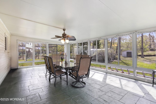 sunroom / solarium with stone tile flooring