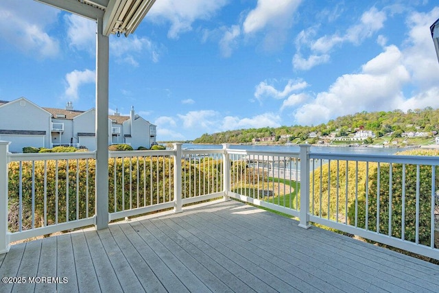 wooden deck featuring a water view