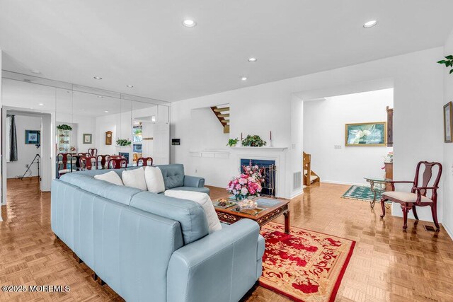 living room with baseboards, recessed lighting, stairs, and visible vents