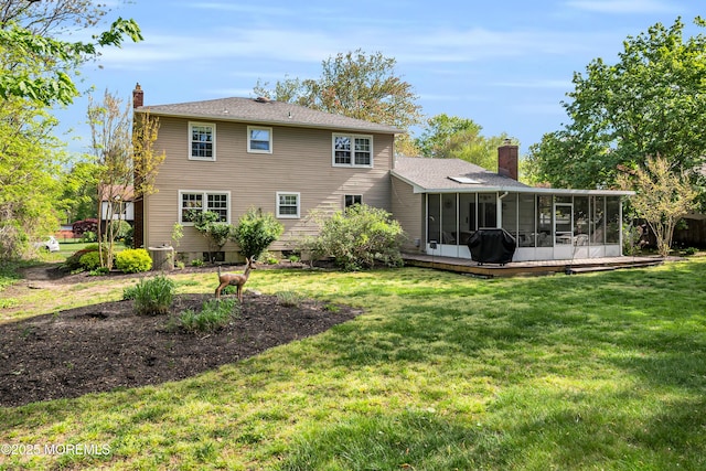 rear view of property featuring a yard, a chimney, a sunroom, and central air condition unit
