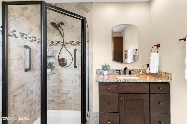 bathroom with vanity and a stall shower