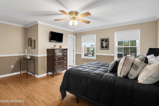 bedroom featuring crown molding, baseboards, ceiling fan, and light wood-type flooring