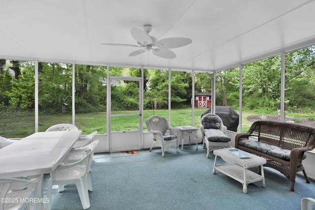 sunroom / solarium with ceiling fan and outdoor lounge area