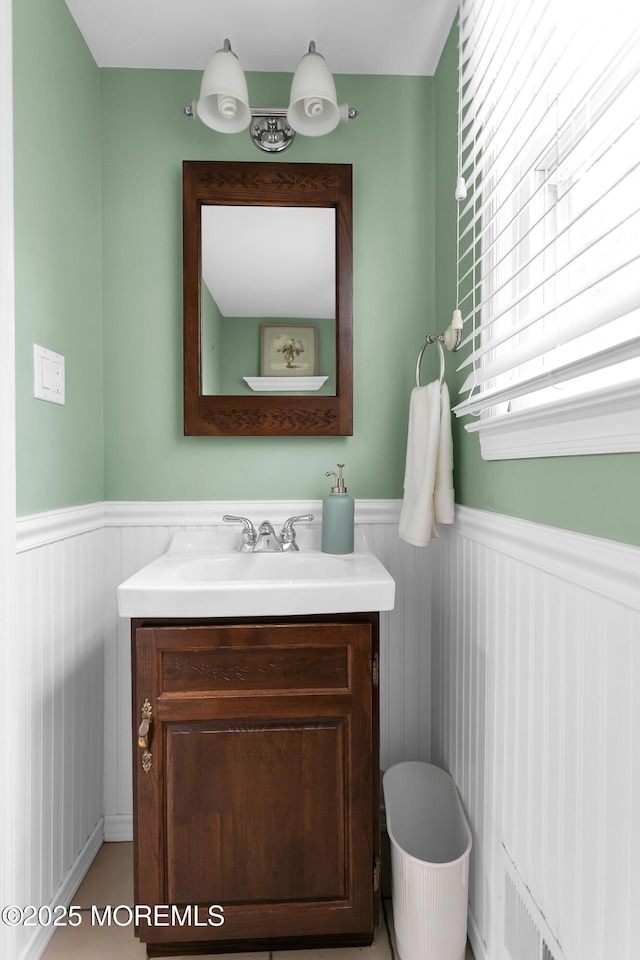 bathroom featuring vanity, wainscoting, and visible vents