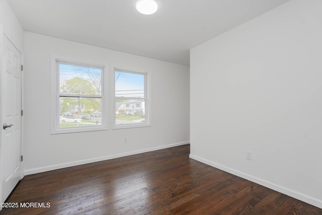 unfurnished room featuring wood finished floors and baseboards