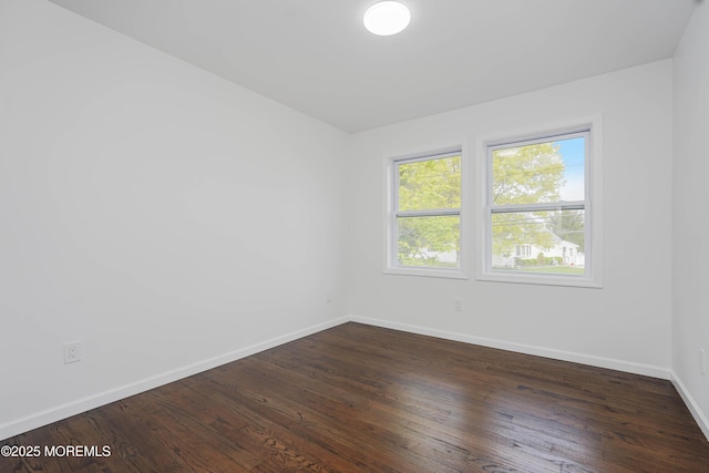 empty room with wood finished floors and baseboards