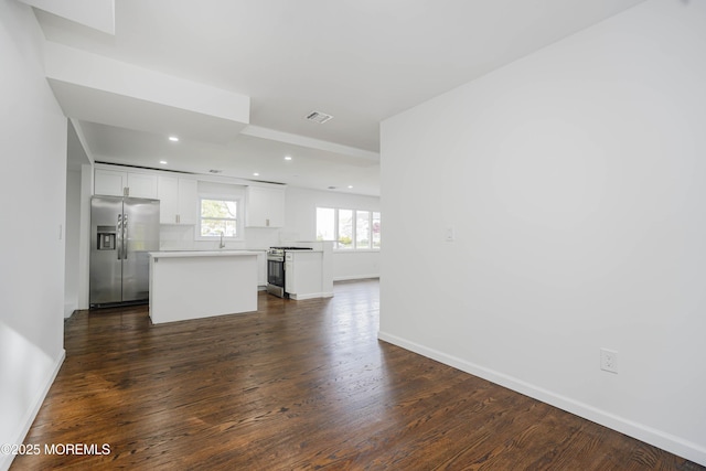 unfurnished living room with recessed lighting, visible vents, dark wood-style flooring, and baseboards