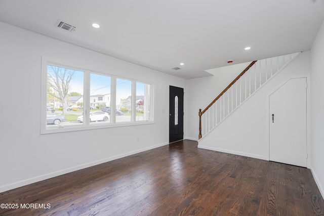 unfurnished living room featuring recessed lighting, stairway, visible vents, baseboards, and dark wood finished floors