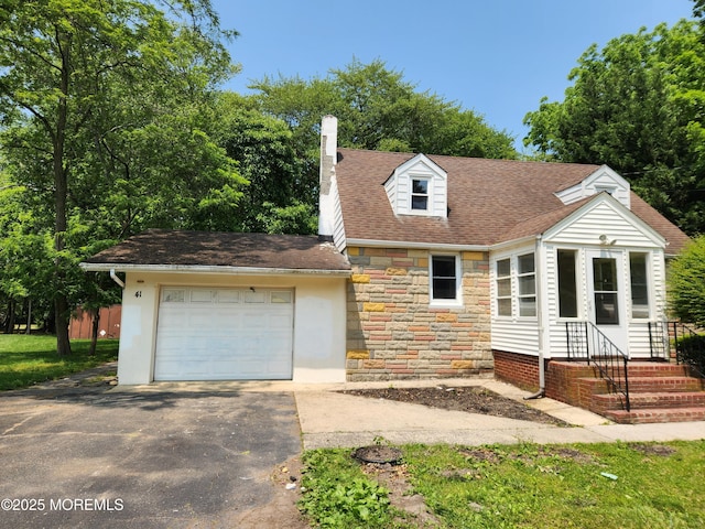 41 Willow Ave, Howell, NJ 07731 - cape cod home with stone siding, a chimney, driveway, an attached garage, and roof with shingles