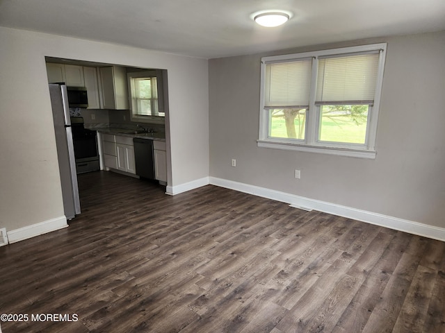 41 Willow Ave, Howell, NJ 07731 - unfurnished living room featuring a sink, baseboards, and dark wood-type flooring