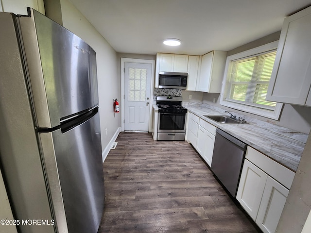 41 Willow Ave, Howell, NJ 07731 - kitchen with appliances with stainless steel finishes, a sink, dark wood-style flooring, white cabinets, and baseboards