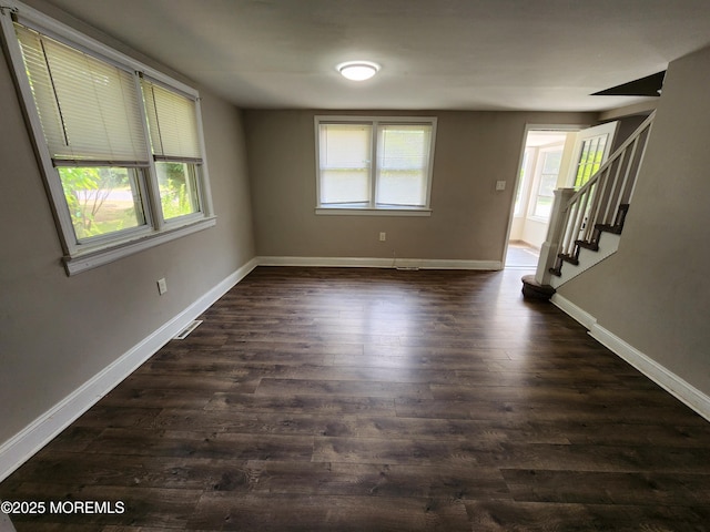 41 Willow Ave, Howell, NJ 07731 - unfurnished room featuring plenty of natural light, dark wood finished floors, baseboards, and stairs