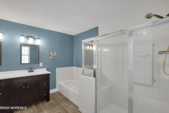 full bathroom with a textured ceiling, wood finished floors, and a stall shower