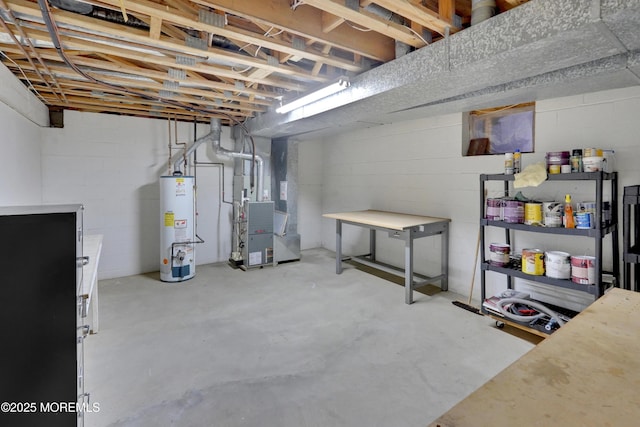 unfinished below grade area featuring heating unit, water heater, and concrete block wall