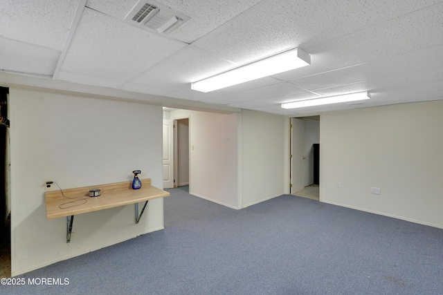 finished basement with carpet floors, baseboards, and visible vents