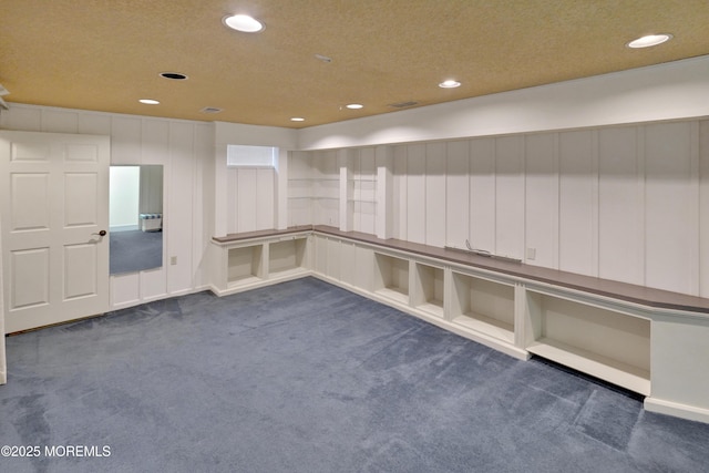 spare room with dark carpet and recessed lighting