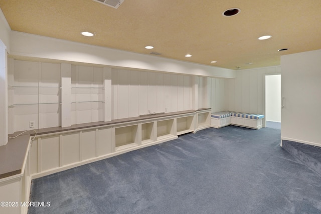 unfurnished room with recessed lighting, dark carpet, and visible vents